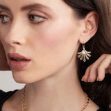 Close up model wearing moonstone and diamond fan earrings 