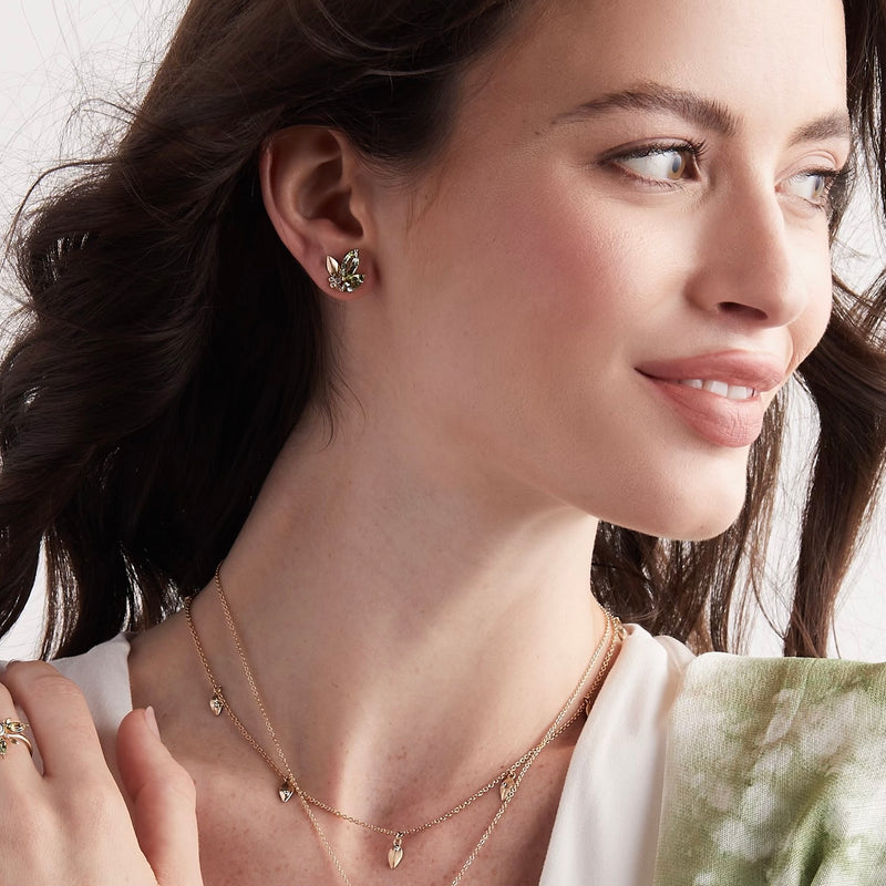 Model wearing tourmaline and gold leaf stud modern organic earrings