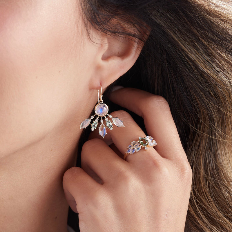Close up model wearing moonstone and tourmaline earrings with diamonds 
