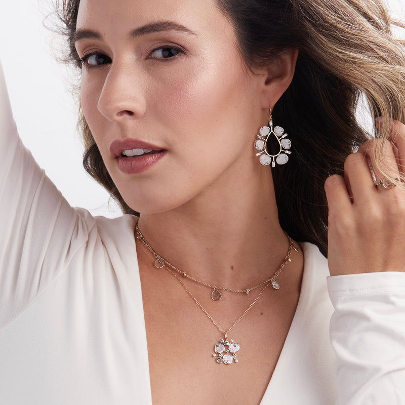 Model wearing diamond slice necklaces and earrings
