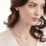 Model wearing 14K gold crescent moon earrings with diamond slices