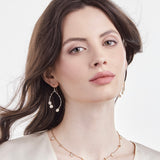 Model wearing diamond slice wishbone earrings by LORIANN