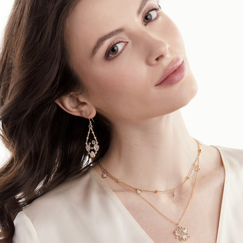 Model wearing diamond slice and green sapphire earrings with diamond slice necklacesnecklaces 