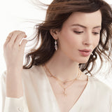Model wearing moonstone and diamond slice earrings with diamond jewelry