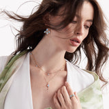 Model wearing moonstone dangle pendant with moonstone and diamond jewelry