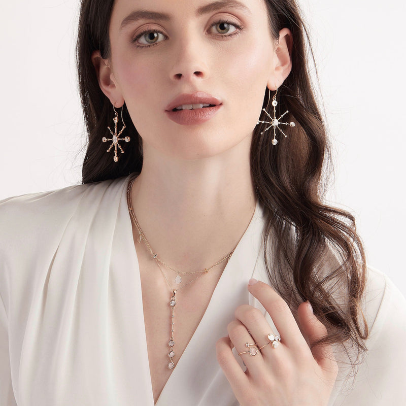 Model waring diamond slice star stement earrings