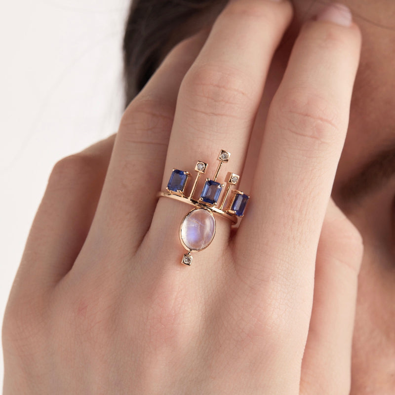 Model wearing moonstone and blue sapphire crown ring
