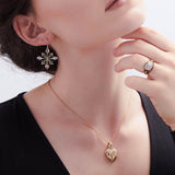Model wearing diamond and gold heart pendant