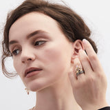 Model wearing enamel and gold scrolled stacking ring