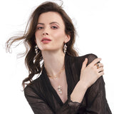 Model wearing diamond slice necklace and earrings with moonstones and black spinel, inspired by Miró, designed by LORIANN jewelry