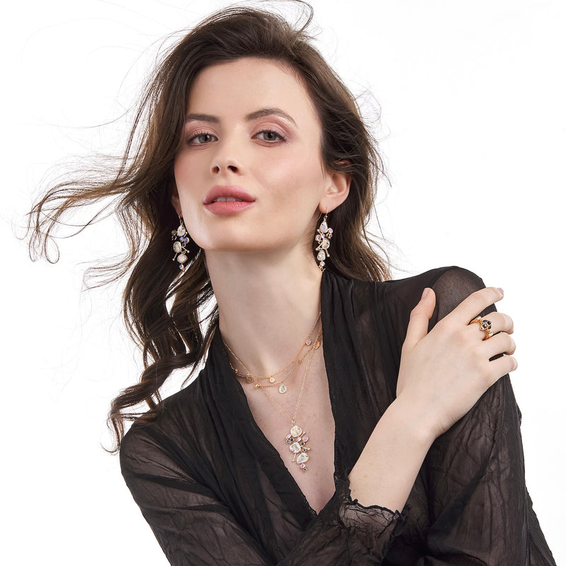 Model wearing diamond slice necklace and earrings with moonstones and black spinel, inspired by Miró, designed by LORIANN jewelry